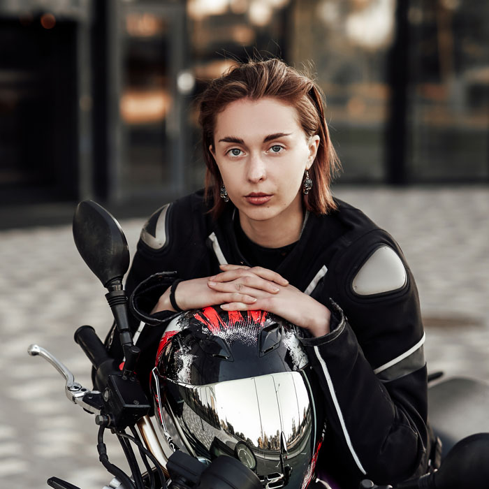 confident-girl-in-a-motorcycle-jacket-sits-with-a-MRXYCSZ.jpg