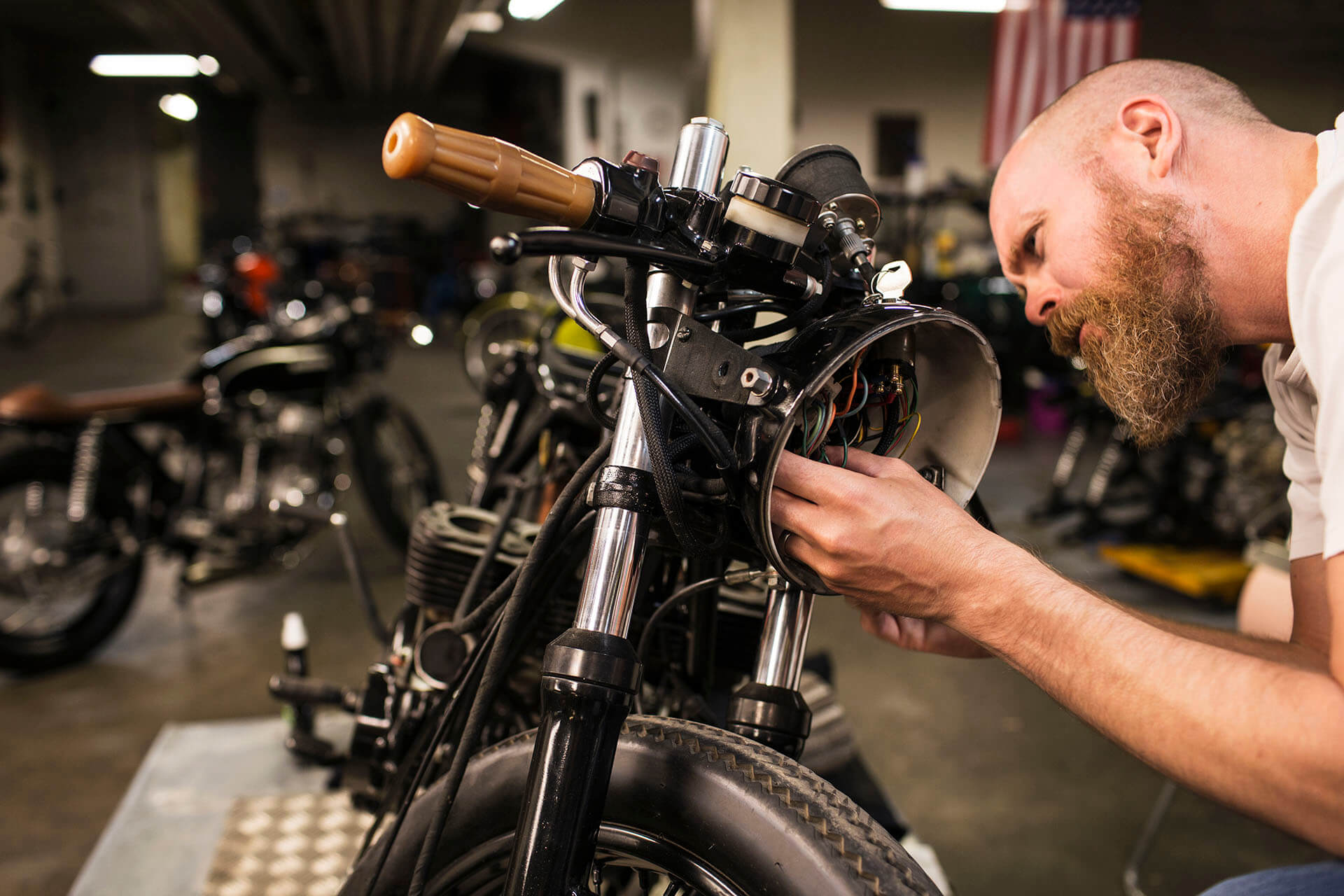 man-repairing-motorcycle-in-workshop-B3SWR6B.jpg